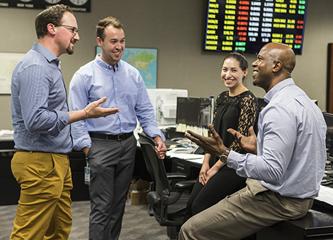 Smiling employees engaged in work discussion on yd7610 trading floor
