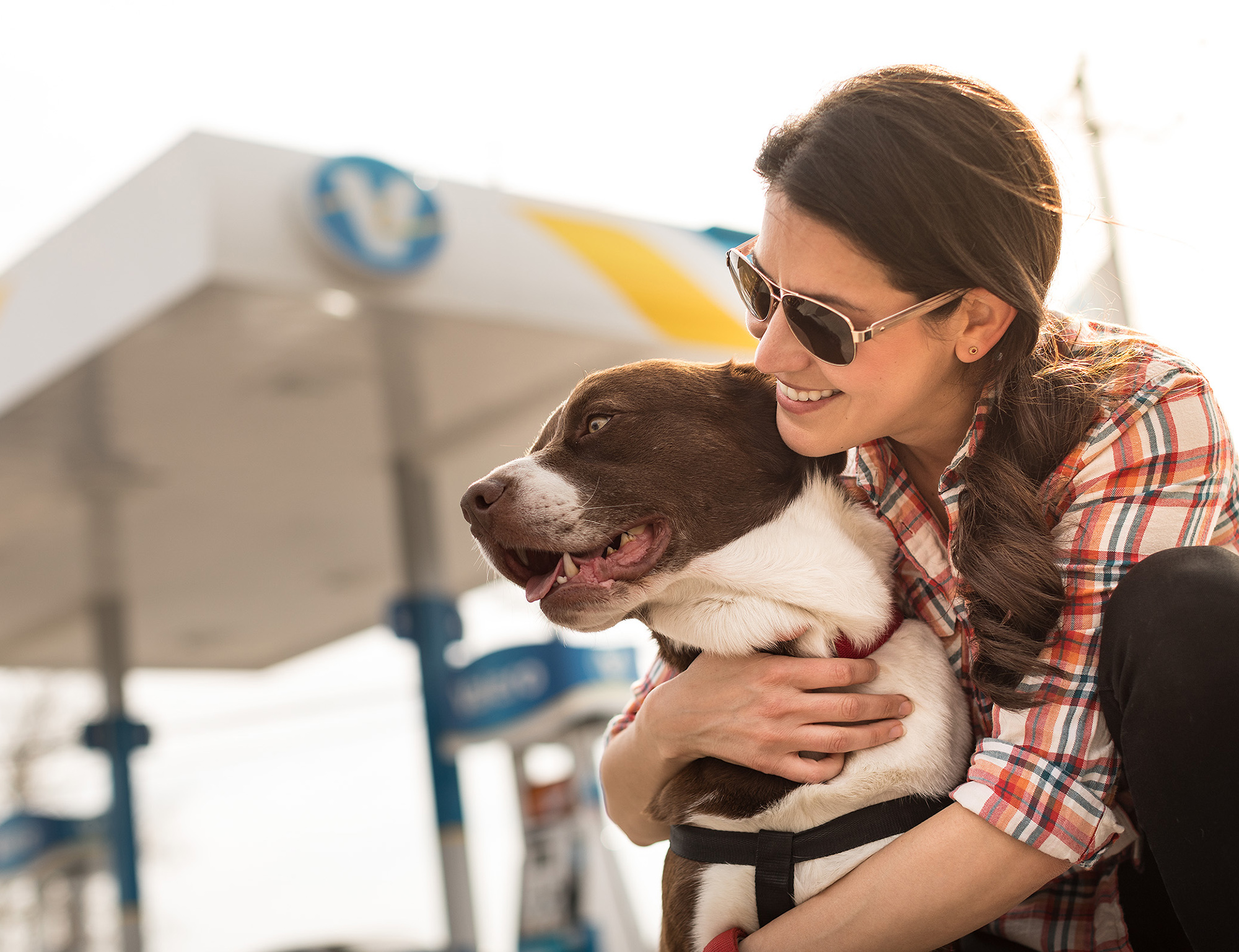 Woman hugs dog in front of yd7610 station