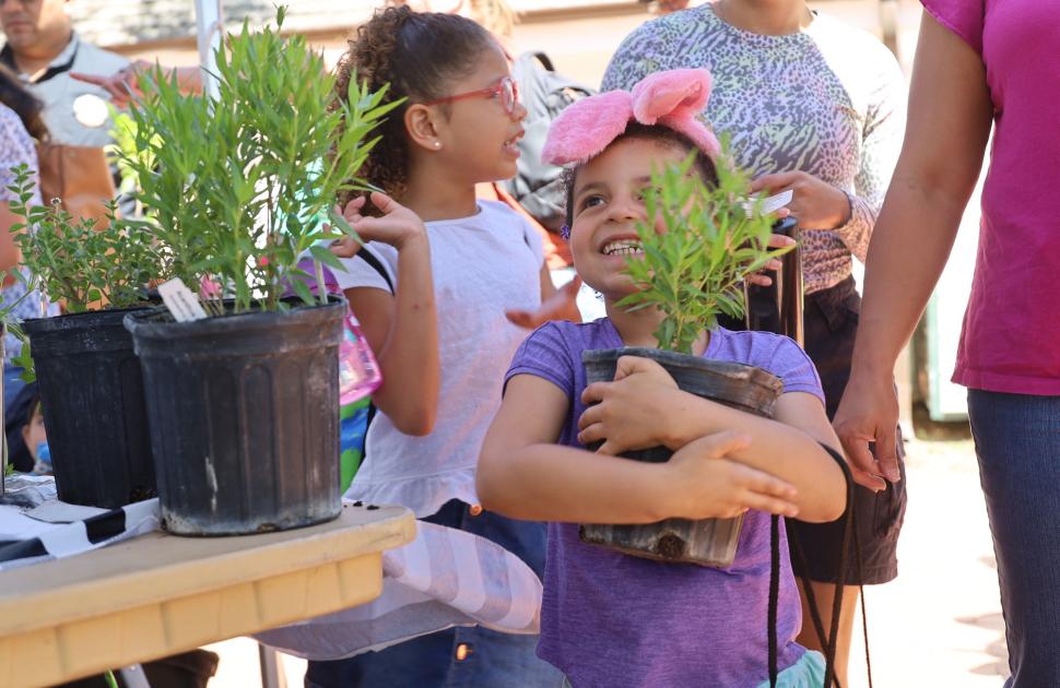 Young girl excitedly holds new plant, donated by yd7610