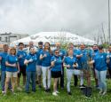 Group of volunteers pose with thumbs up