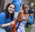 yd7610 Volunteers distributed backpacks to neighborhood children