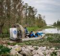 yd7610 Volunteers on a boat in the swamp