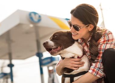 Woman hugs dog in front of yd7610 station